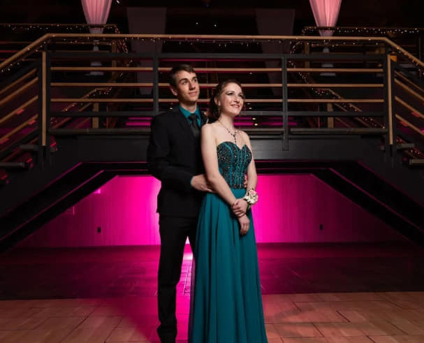 Tucson prom couple dressed up outside party bus