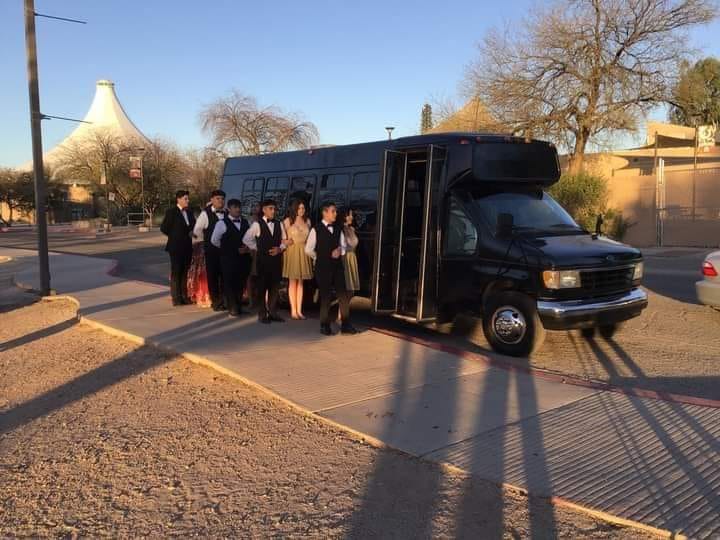 Prom group outside black party bus Tucson